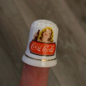 Vintage Coca-Cola Ceramic Sewing Thimble
Girl Advertising Bottle of Coke